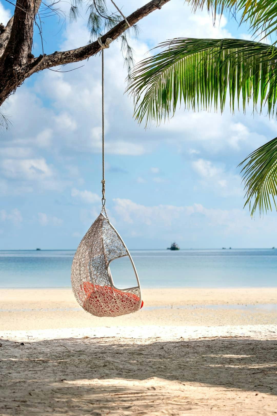 Hammock attached to a palm tree in a tropical Island